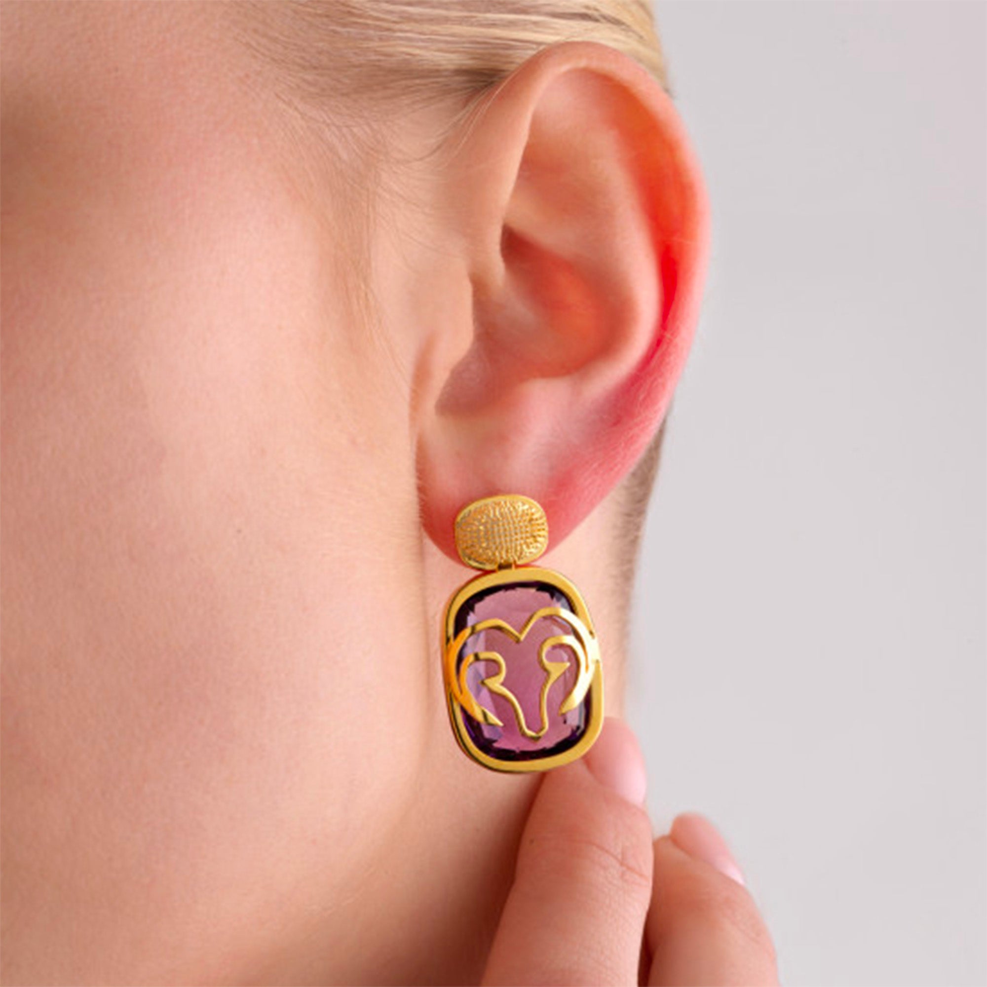 The Maje Earrings worn by a model